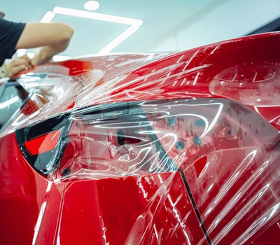 Close-up of a vehicle's surface coated with Paint Protection Film, offering scratch resistance.