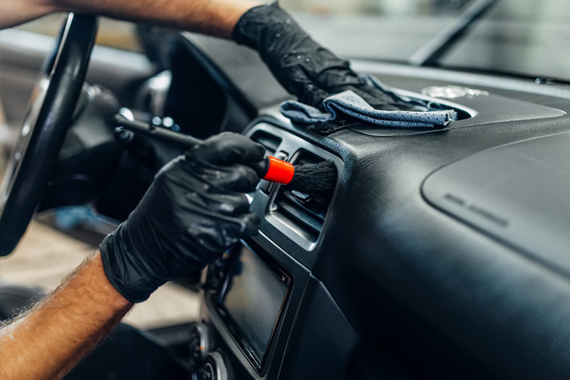 Close-up view of a car's exterior being professionally detailed, showcasing a high-quality finish and attention to detail in the cleaning and polishing process.