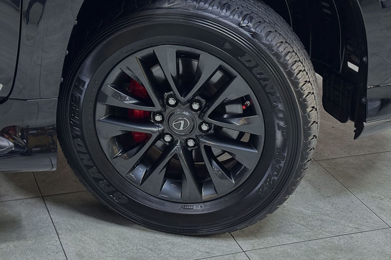 A mechanic repairing a damaged wheel, demonstrating professional wheel repair services with precision and expertise.